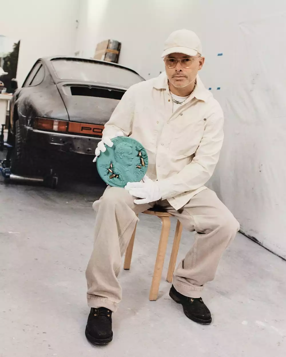 Daniel Arsham holding the Bronze Eroded Penny Vessel sculpture