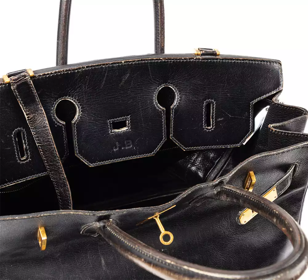 Close-up of the initials J.B. on Jane Birkin's Hermès bag