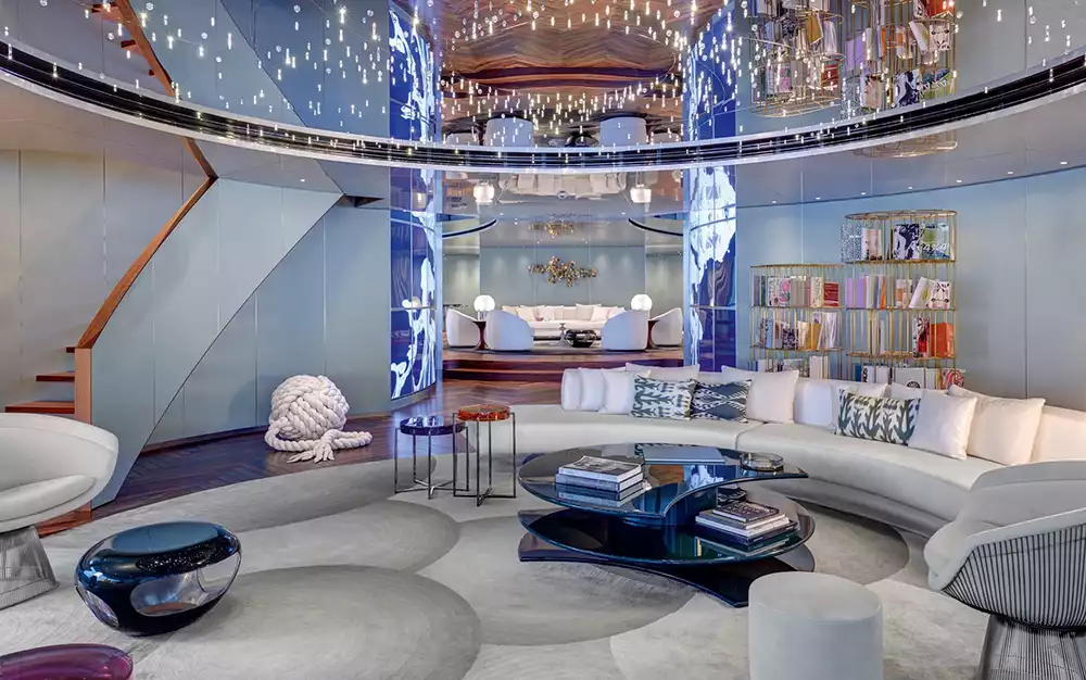 Luxurious main salon of the Savannah superyacht with curved sofas and circular video walls