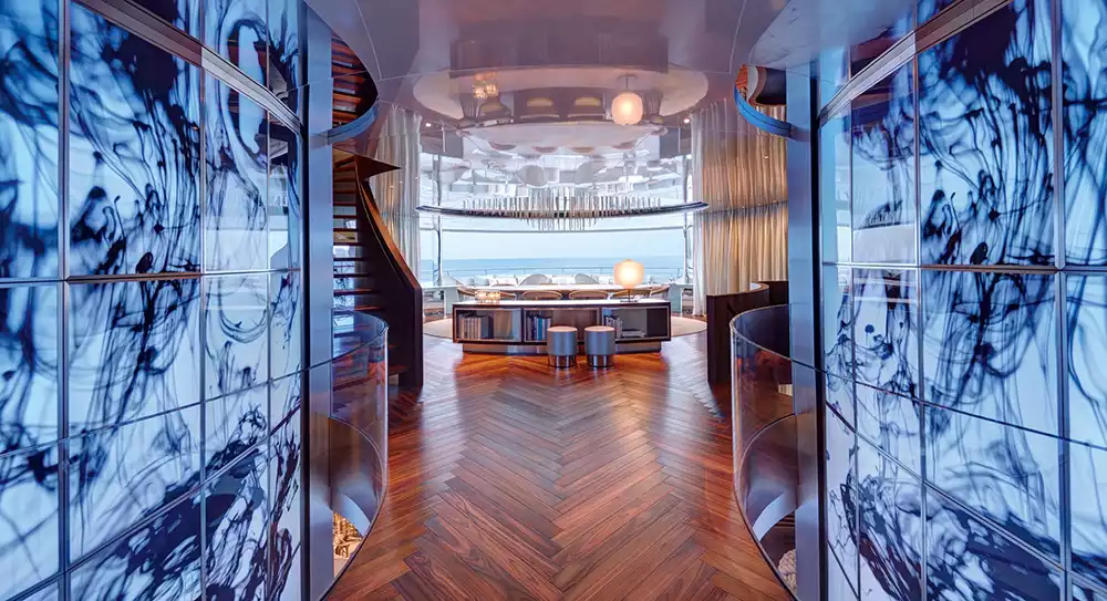 Elegant interior view of the Savannah yacht's salon with artistic blue glass partitions