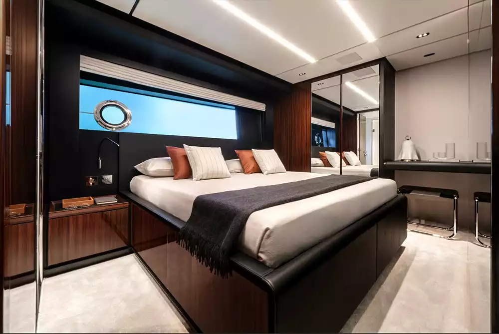 Master suite on the lower deck featuring polished rosewood and leather accents