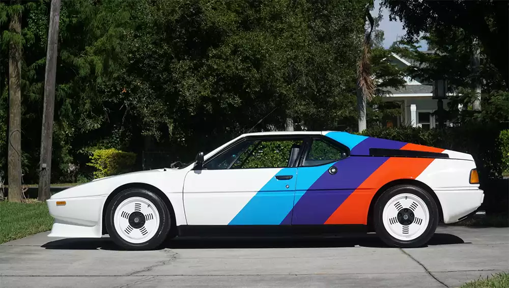 Side profile of the BMW M1 showing Procar livery and white Campagnolo wheels