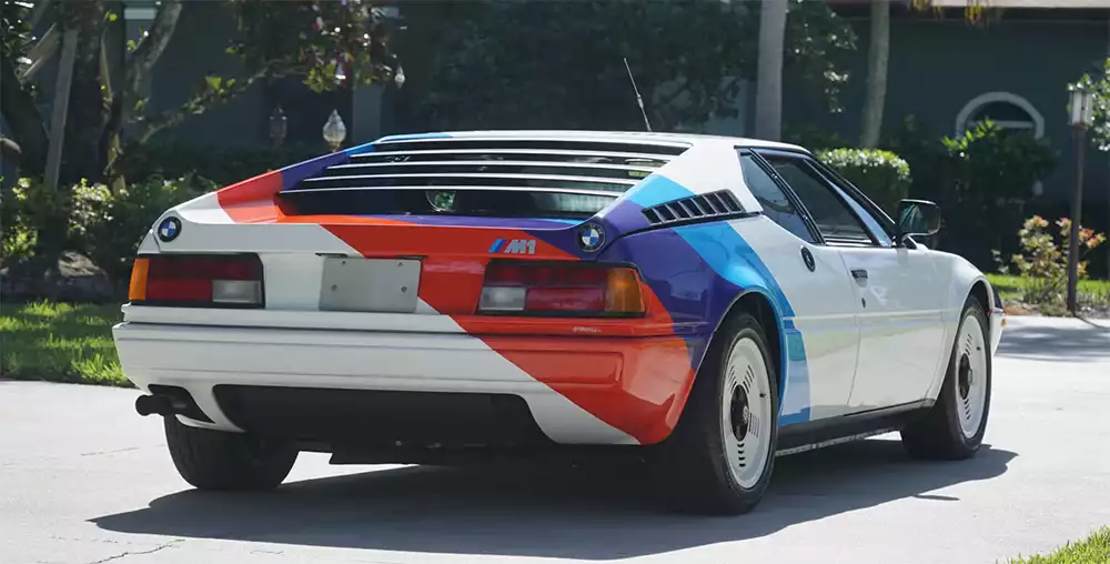Rear view of the BMW M1 showing the louvers, BMW badge, and antenna