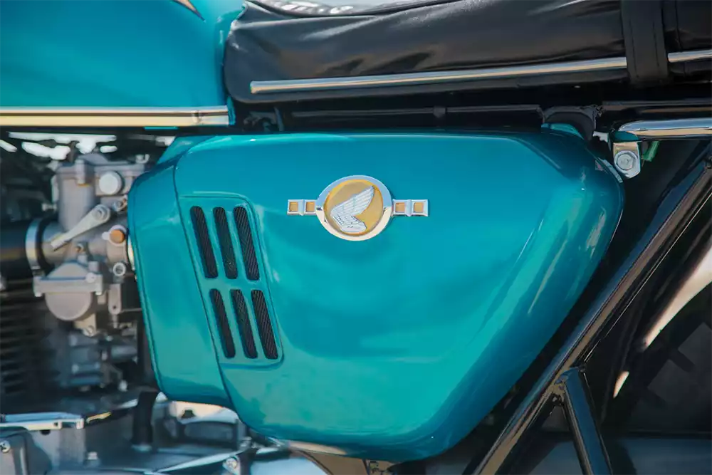 Close up of the teal fuel tank and Honda wing emblem on the prototype