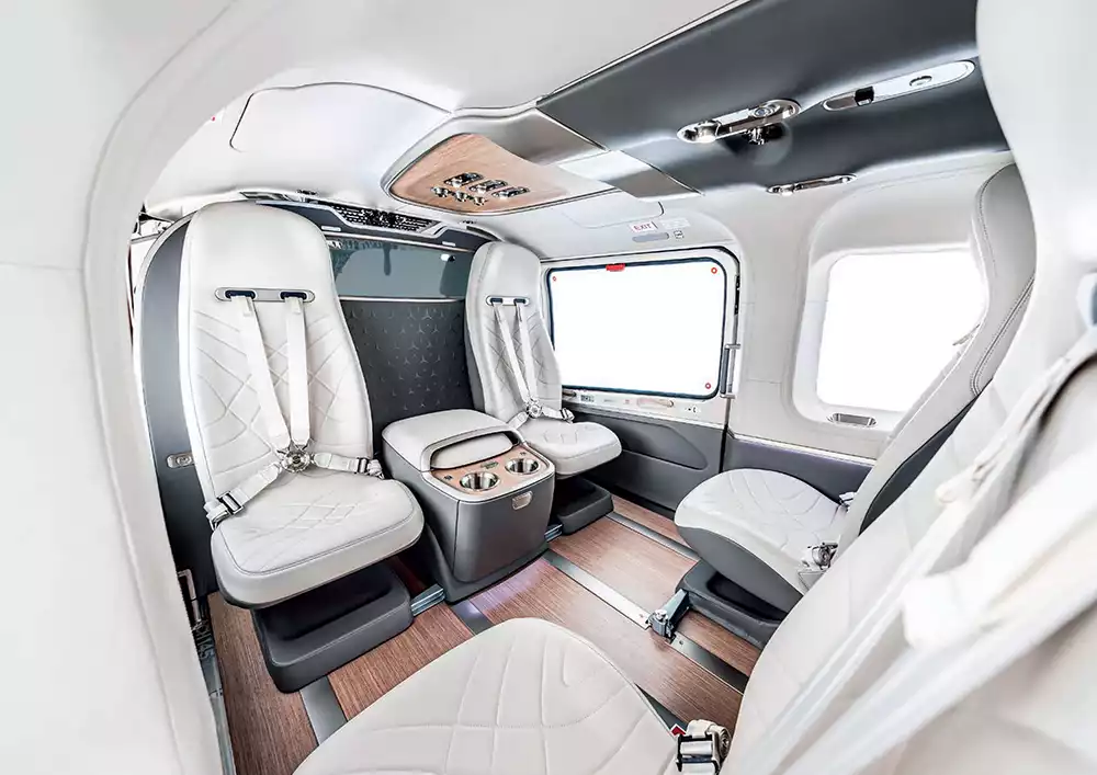 Elegant interior view of the Airbus ACH145 Mercedes-Benz Edition, highlighting modular seating, sophisticated materials, and ample legroom
