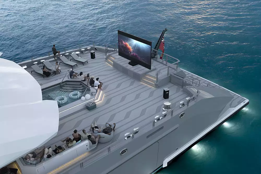 Open-air cinema and aft deck seating illuminated at night on superyacht Leviathan