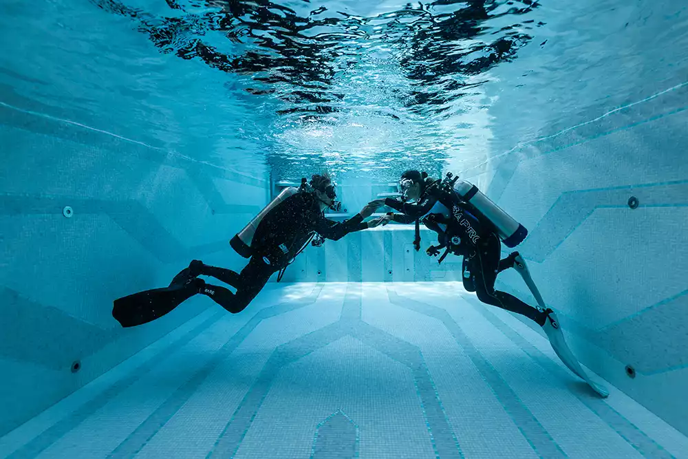 Divers exploring underwater representing the dive centre onboard Leviathan's Inkfish fleet