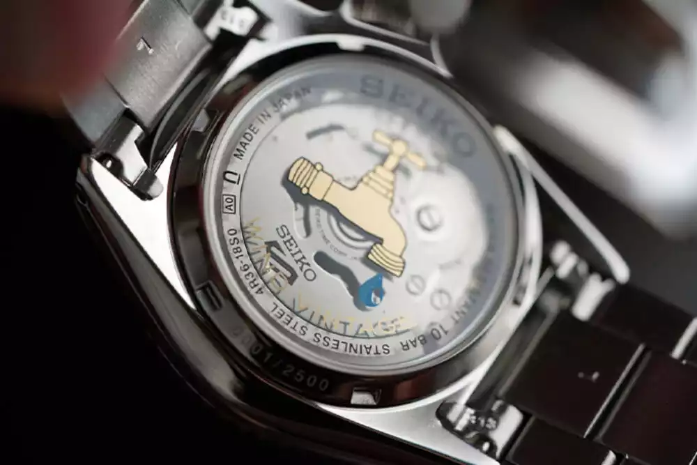 Exhibition caseback of Seiko 5 Sports Rally Diver showing caliber 4R36 movement and Wind Vintage graphic
