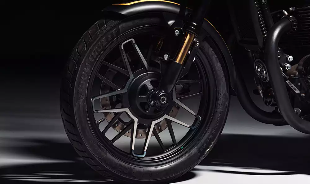 Front wheel details and gold forks on the custom Royal Enfield Shotgun 650 Rough Crafts motorcycle