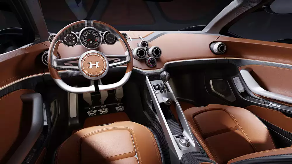 Tan leather interior and steering wheel of the analog Hennessey Blackbird cabin