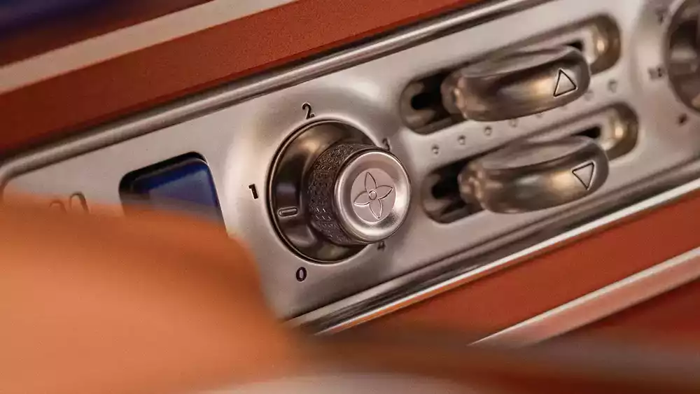 Close-up of the bespoke metallic dials and dashboard controls on the Singer Porsche 911